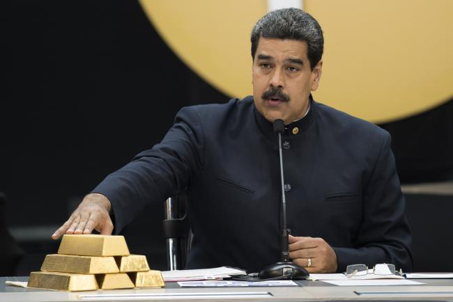 &copy Bloomberg. Nicolas Maduro speaks as he touches a stack of gold ingots in Caracas, in March 2018. Photographer: Carlos Becerra/Bloomberg