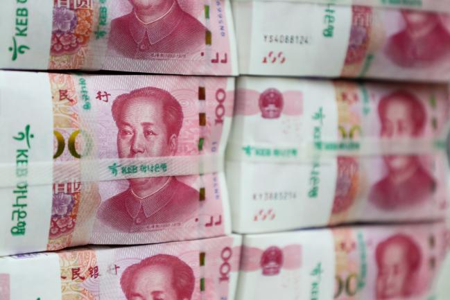 © Bloomberg. Genuine bundles of Chinese one-hundred yuan banknotes are arranged for a photograph at the Counterfeit Notes Response Center of KEB Hana Bank in Seoul, South Korea, on Friday, July 13, 2017. Yuan is set to slide for fifth week, longest losing streak since July 2016, as escalating U.S.-China trade tensions weigh on sentiment. 