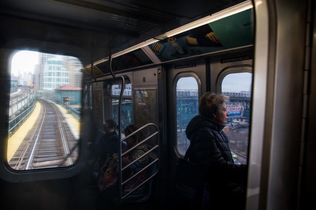 © Bloomberg. Commuters ride an subway train in the Queens borough of New York, U.S., on Friday, March 29, 2019. Stocks climbed to round out a strong quarter and Treasuries fell amid hopes for a trade deal between the world's two largest economies. Photographer: Michael Nagle/Bloomberg