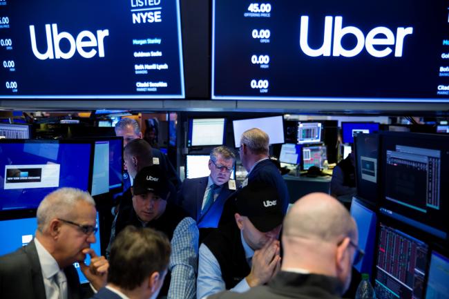 © Bloomberg. Traders work on the floor during Uber Technologies Inc.'s initial public offering (IPO) at the New York Stock Exchange (NYSE) in New York, U.S., on Friday, May 10, 2019. The No. 1 ride-hailing company's shares will start trading on the New York Stock Exchange after it raised $8.1 billion in the biggest U.S. IPO since 2014, pricing shares at $45 each. 