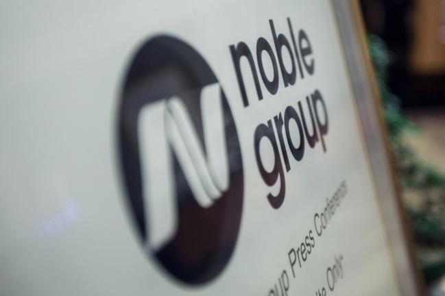 © Bloomberg. Noble Group Ltd. signage sits on display outside during an investor day in Singapore, on Monday, Aug. 17, 2015. Noble pledged to increase operating profit to more than $2 billion in the next three to five years as Asia\\'s largest commodity trader sought to reassure investors about its long-term prospects.