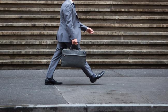 © Bloomberg. A pedestrian walks along Wall Street near the New York Stock Exchange (NYSE) in New York, U.S., on Wednesday, Sept. 6, 2017. Markets stabilized Wednesday, even as North Korean tensions continued to simmer, another hurricane tore through the Caribbean and a key member of the Fed resigned. 