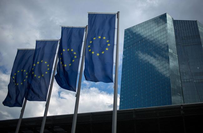 © Bloomberg. The stars of the European Union (EU) sit on banners flying outside the European Central Bank (ECB) headquarters stands in Frankfurt, Germany, on Thursday, July 20, 2017. Frankfurt has emerged as a winner of the Brexit vote, with Standard Chartered Plc, Nomura Holdings Inc., Sumitomo Mitsui Financial Group Inc. and Daiwa Securities Group Inc. picking the city as their EU hub in recent weeks.