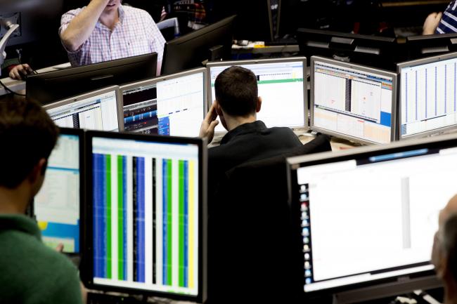 © Bloomberg. A trader looks over computer monitors as he works in the Cboe Volatility Index (VIX) pit on the floor of the Cboe Global Markets, Inc. exchange in Chicago, Illinois, U.S., on Wednesday, Feb. 14, 2018. Signs of an inflation pickup have roiled financial markets this month, and stock futures tumbled early Wednesday on concern the Fed would quicken its pace of tightening following data that showed faster-than-forecast inflation. Those fears receded as investors digested a separate report showing weak retail sales that raised questions about the economys strength. Photographer: Daniel Acker/Bloomberg