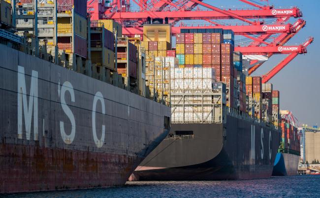 © Bloomberg. Cargo ships line up at the Total Terminals berth at the Port of Long Beach in Long Beach, California, U.S., on Wednesday, April 4, 2018. The U.S. trade deficit widened by more than forecast to a fresh nine-year high in February amid broad-based demand for imports, ahead of Trump administration tariffs that have raised the specter of a trade war. 