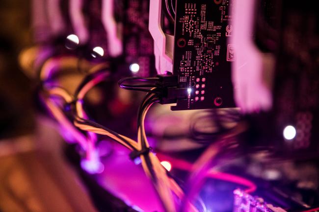 © Bloomberg. Nvidia Corp. GeForce GTX 1070 graphic processing units (GPU) sit stacked inside a 'mining rig' computer, used to mine the Ethereum cryptocurrency, in Budapest, Hungary. Photographer: Akos Stiller/Bloomberg