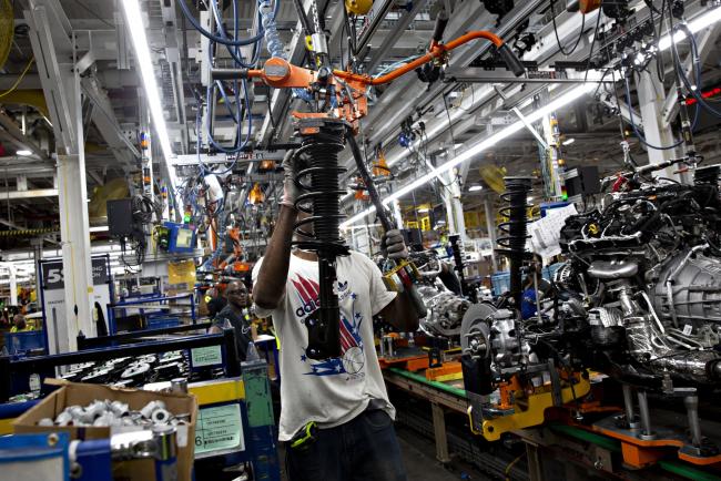 © Bloomberg. An employee places a suspension vehicle component on a hanging conveyor at the Ford Motor Co. Chicago Assembly Plant in Chicago, Illinois, U.S., on Monday, June 24, 2019. Ford invested $1 billion in Chicago Assembly and Stamping plants and added 500 jobs to expand capacity for the production of all-new Ford Explorer, Explorer Hybrid, Police Interceptor Utility and Lincoln Aviator. Photographer: Daniel Acker/Bloomberg
