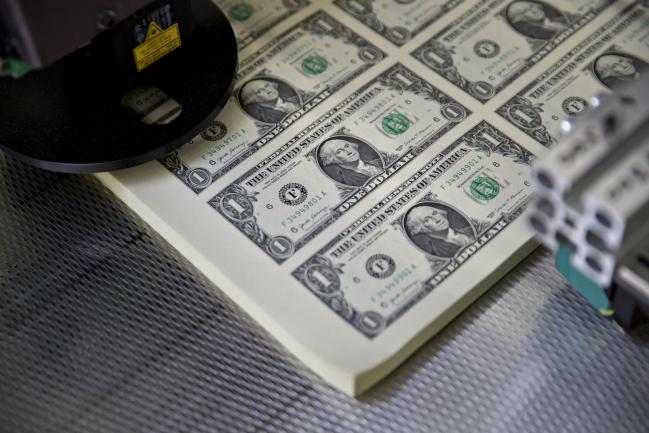 © Bloomberg. Stacks of 2017 50 subject uncut sheets of $1 dollar notes bearing the name of U.S. Treasury Secretary Steven Mnuchin sit in a machine at the U.S. Bureau of Engraving and Printing in Washington, D.C., U.S., on Wednesday, Nov. 15, 2017. A change in the Senate tax-overhaul plan that would expand a temporary income-tax break for partnerships, limited liability companies and other so-called 