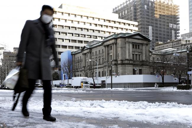 © Bloomberg. A pedestrian walks past the Bank of Japan (BOJ) headquarters in Tokyo, Japan.