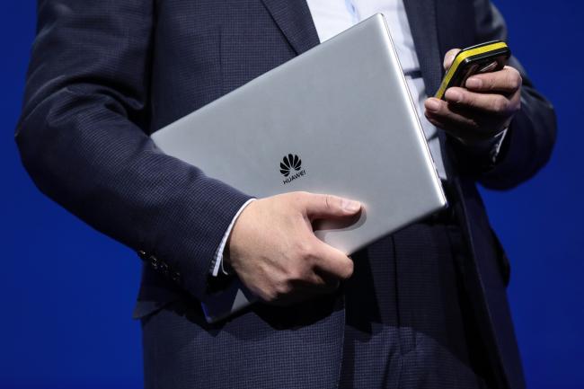 © Bloomberg. Richard Yu, chief executive officer of Huawei Technologies Co., holds a MateBook X Pro laptop computer during a Huawei Technologies Co. launch event ahead of the Mobile World Congress (MWC) in Barcelona, Spain, on Sunday, Feb. 25, 2018. At the wireless industry’s biggest conference, more than 100,000 people are set to see the latest smartphones, artificial intelligence devices and autonomous drones exhibited by roughly 2,300 companies. 