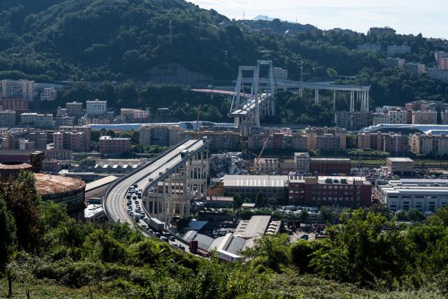 © Bloomberg. The remains of the Morandi motorway bridge stands after it partially collapsed in Genoa, Italy, on Wednesday, Aug. 15, 2018. 