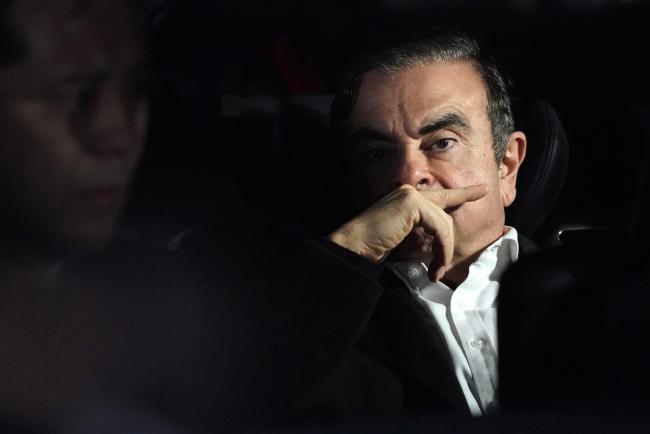 © Bloomberg. Carlos Ghosn, former chairman of Nissan Motor Co., sits in a vehicle as he leaves his lawyer's office in Tokyo, Japan, on Wednesday, March 6, 2019.