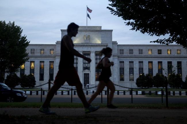 © Bloomberg. A pedestrian walks past the Marriner S. Eccles Federal Reserve building stands in this photograph taken with a tilt-shift lens in Washington, D.C., U.S., on Tuesday, Sept. 1, 2015.  Photographer: Andrew Harrer/Bloomberg 