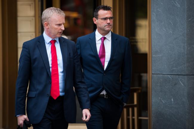 © Bloomberg. Richard Usher, right, leaves federal court on July 17, 2017.