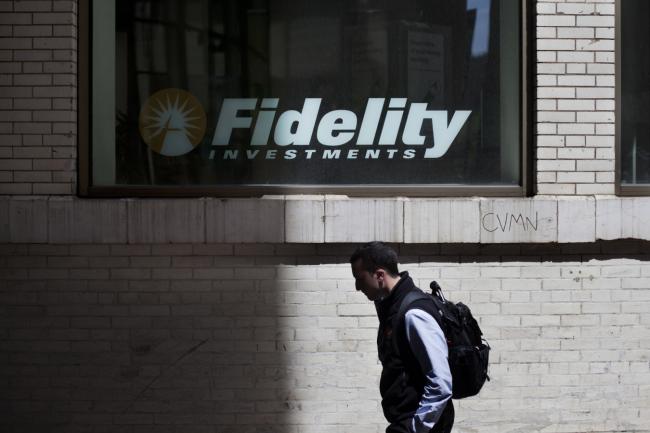 © Bloomberg. A pedestrian passes a Fidelity Investments branch in New York, U.S., on Monday, April 30, 2012.