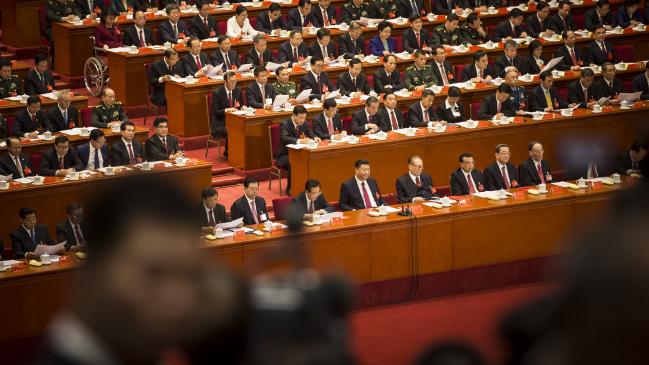 © Bloomberg. Xi Jinping, China's president, front row center, and other leaders and delegates attend the closing session of the 19th National Congress of the Communist Party of China at the Great Hall of the People in Beijing, China, on Tuesday, Oct. 24, 2017. China's ruling Communist Party approved a revised charter that enshrined Xi'sname under its guiding principles, elevating him to a status that eluded his two immediate predecessors.