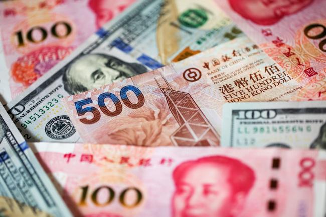 © Bloomberg. A Hong Kong five-hundred dollar banknote, Chinese one-hundred yuan banknotes and U.S. one-hundred dollar banknotes are arranged for a photograph in Hong Kong, China, on Monday, April 15, 2019. China's holdings of Treasury securities rose for a third month as the Asian nation took on more U.S. government debt amid the trade war between the world’s two biggest economies. 