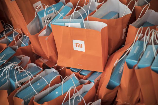 © Bloomberg. Gift bags sit stacked during the unveiling event for the Xiaomi Corp. Mi MIX 2S smartphone in Shanghai, China, on Tuesday, March 27, 2018. Xiaomi unveiled its latest top-tier smartphone to bring the fight to Apple and Samsung, as the Chinese startup readies a highly anticipated initial public offering. Photographer: Qilai Shen/Bloomberg