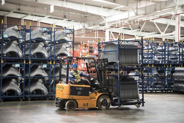 &copy Bloomberg. An employee uses a forklift to transport vehicle panels through the press shop at the SAIC-GM-Wuling Automobile Co. Baojun Base plant, a joint venture between SAIC Motor Corp., General Motors Co. and Liuzhou Wuling Automobile Industry Co., in Liuzhou, Guangxi province, China, on Wednesday, May 23, 2018. GM and its partners sold 4 million vehicles in China in 2017, about 1 million more than the automaker sold in the U.S. Photographer: Qilai Shen/Bloomberg