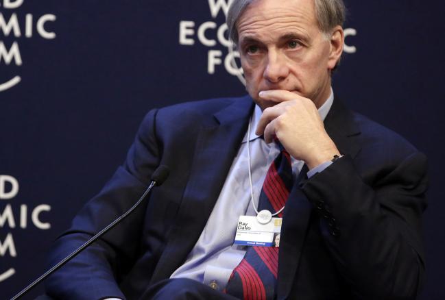 © Bloomberg. Raymond 'Ray' Dalio, billionaire and founder of Bridgewater Associates LP, pauses during a session on the opening day of the World Economic Forum (WEF) in Davos, Switzerland, on Wednesday, Jan. 22, 2014. World leaders, influential executives, bankers and policy makers attend the 44th annual meeting of the World Economic Forum in Davos, the five day event runs from Jan. 22-25.