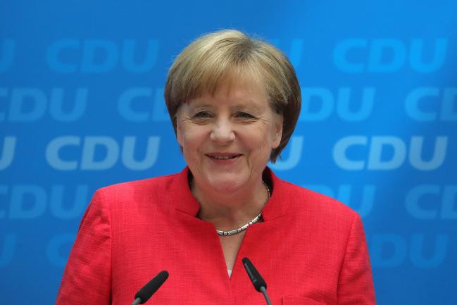 © Bloomberg. Angela Merkel, Germany's chancellor and leader of the Christian Democratic Union (CDU) party, reacts during a news conference at the CDU headquarters in Berlin, Germany, on Monday, June 18, 2018. 