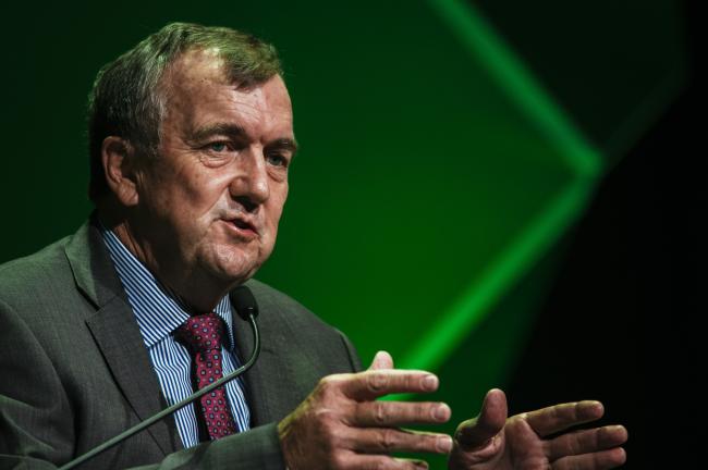 © Bloomberg. Mark Bristow, chief executive officer of Randgold Resources Ltd., gestures as he speaks during a panel discussion on the second day of the Investing in African Mining Indaba in Cape Town, South Africa, on Tuesday, Feb. 6, 2018. Mining executives, investors and government ministers are meeting in drought-hit Cape Town for the African Mining Indaba, the continent’s biggest gathering of one of its most vital industries. 