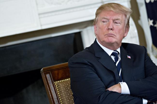 © Bloomberg. U.S. President Donald Trump participates in a listening session on gun violence with high school students, teachers and parents in the State Dining Room of the White House in Washington, D.C., U.S., on Wednesday, Feb. 21, 2018. Trump promised on Wednesday to act quickly to prevent more school shootings as often-tearful, occasionally angry survivors and parents of victims poured out their frustration to him in a remarkable White House meeting.