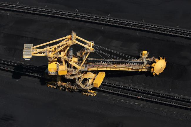 © Bloomberg. A stacker-reclaimer operates next to stockpiles of coal at the Newcastle Coal Terminal in this aerial photograph taken in Newcastle, Australia. 