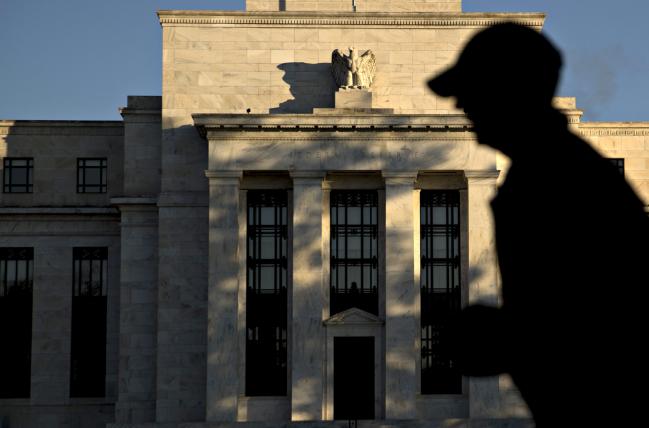 © Bloomberg. A runner passes the Marriner S. Eccles Federal Reserve building in Washington, D.C., U.S., on Friday, Nov. 18, 2016. Federal Reserve Chair Janet Yellen told lawmakers on Thursday that she intends to stay in the job until her term expires in January 2018 while extolling the virtues of the Fed's independence from political interference.