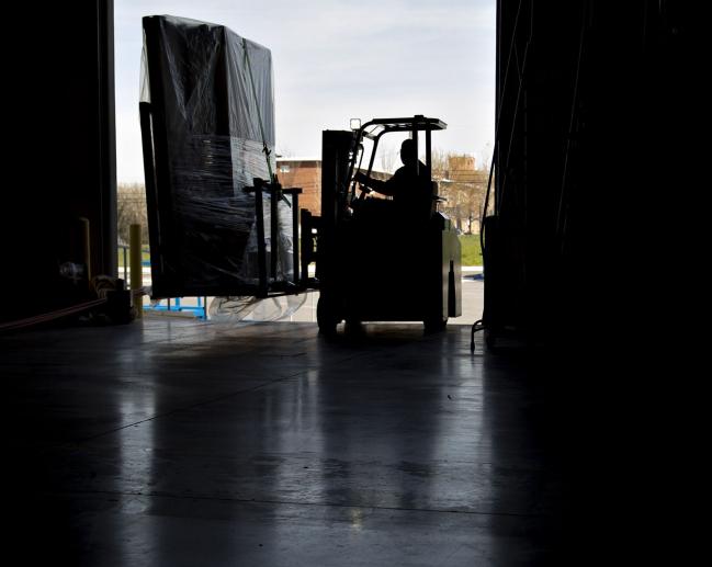 © Bloomberg. An employee moves an order of walls on a forklift in Baltimore, Maryland. 