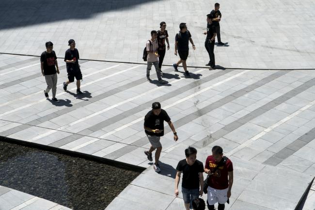 © Bloomberg. People walk through a plaza at Soho China Ltd.'s Sanlitun Soho development in Beijing, China, on Friday, June 1, 2018. The People's Bank of China announced on Friday that it would add debt instruments tied to small-business and the green economy. 