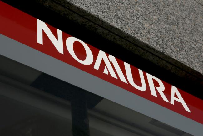 © Bloomberg. The Nomura Holdings Inc. logo is displayed outside a Nomura Securities Co. branch in Tokyo, Japan, on Wednesday, Nov. 30, 2016. A recovery in Nomura's businesses outside of Japan is continuing in the current quarter, Nomura Chief Executive Officer Koji Nagai said at an investor forum today. Photographer: Yuriko Nakao/Bloomberg