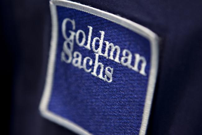 © Bloomberg. A patch bearing the Goldman Sachs Group Inc. logo is pictured on a trading jacket on the floor of the New York Stock Exchange in New York, U.S. 