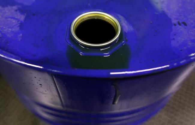 © Bloomberg. Excess fluid sits on the rim of a barrel of oil based lubricant at Rock Oil Ltd.'s factory in Warrington, U.K., on Monday, March 13, 2017. Oil declined after Saudi Arabia told OPEC it raised production back above 10 million barrels a day in February, reversing about a third of the cuts it made the previous month. Photographer: Chris Ratcliffe/Bloomberg