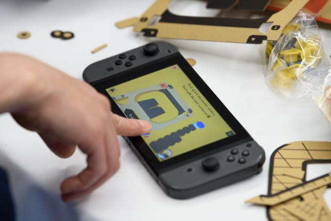 © Bloomberg. The screen of a Nintendo Co. Switch game console displays instructions for building the company's Labo VR Kit headset in this arranged photograph taken in Tokyo, Japan, on Friday, April 12, 2019. The VR kit, which went on sale Friday and starts at $40, is a build-it-yourself set of cardboard goggles and controllers for Nintendo's Switch console. Photographer: Akio Kon/Bloomberg