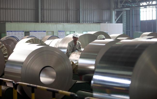 © Bloomberg. A worker handles a roll of steel at the Baosteel Group Corp. facilities in Shanghai, China, on Friday, April 15, 2011. 