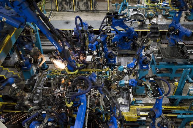 © Bloomberg. Sparks fly as robotic arms perform inner frame welds for 2018 Honda Accord vehicles during production at the Honda of America Manufacturing Inc. Marysville Auto Plant in Marysville, Ohio, U.S., on Thursday, Dec. 21, 2017. More than three decades after Honda Motor Co. first built an Accord sedan at its Marysville factory in 1982, humans are still an integral part of the assembly process -- and that's unlikely to change anytime soon. Photographer: Ty Wright/Bloomberg