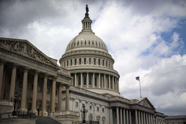 © Bloomberg. An American flag flies outside the Capitol building in Washington, D.C., U.S., on Thursday, June 21, 2018. Senate Democratic leader Chuck Schumer and House Minority Leader Nancy Pelosi want President Trump's administration to 