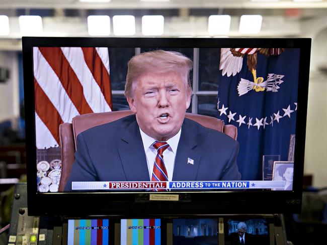 © Bloomberg. A television monitor in the White House press briefing room broadcasts U.S. President Donald Trump's address on border security in Washington, D.C., U.S., on Tuesday, Jan. 8, 2019. Trump demanded Congress provide billions more for border security in a prime-time address to the nation, stopping short of declaring a national emergency and giving little indication of a quick end to a paralyzing political dispute over his proposed wall on the Mexican border. Photographer: Andrew Harrer/Bloomberg
