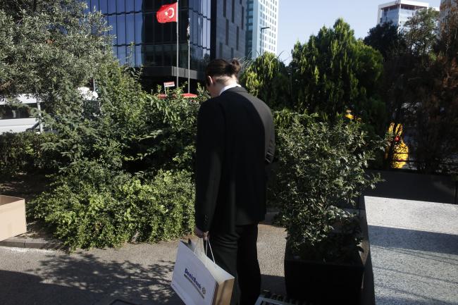 © Bloomberg. A man carries a Denizbank AS shopping bag in the district of Maslak, Istanbul, Turkey, on Friday, July 6, 2018. Recep Tayyip Erdogan, Turkey's longest-serving ruler since the Republic was founded in 1923, won a five-year term on June 24, securing a mandate to rule with greater executive powers. He has already governed three times as prime minister and served one term as president. Photographer: Kostas Tsironis/Bloomberg