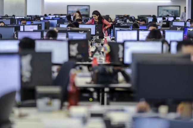 © Bloomberg. Employees work at the office of Trafigura India Private Ltd., a subsidiary of Trafigura Group Pte., in Mumbai, India. Photographer: Dhiraj Singh/Bloomberg