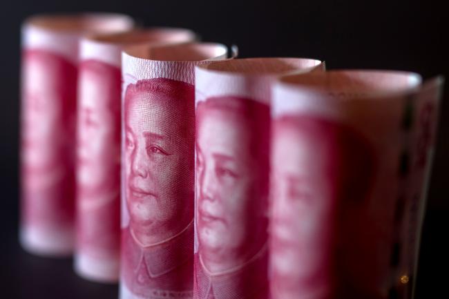 © Bloomberg. Chinese one-hundred yuan banknotes are arranged for a photograph in Hong Kong, China, on Monday, April 15, 2019. China's holdings of Treasury securities rose for a third month as the Asian nation took on more U.S. government debt amid the trade war between the world’s two biggest economies. Photographer: Paul Yeung/Bloomberg