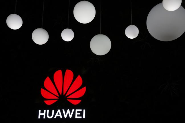 © Bloomberg. An illuminated Huawei Technologies Co. logo is displayed above their stand on the opening day of the MWC Barcelona in Barcelona, Spain, on Monday, Feb. 25, 2019. At the wireless industry’s biggest conference, over 100,000 people are set to see the latest innovations in smartphones, artificial intelligence devices and autonomous drones exhibited by more than 2,400 companies. Photographer: Stefan Wermuth/Bloomberg