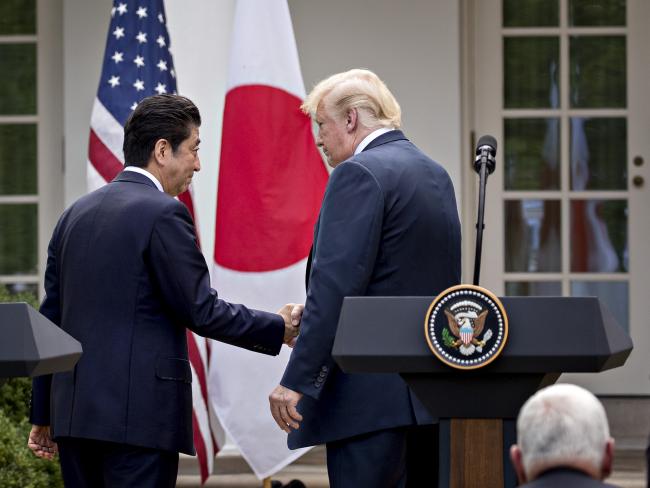 © Bloomberg. U.S. President Donald Trump, right, shakes hands with Shinzo Abe, Japan's prime minister, during a news conference in the Rose Garden of the White House in Washington, D.C. on June 7, 2018. Photographer: Andrew Harrer/Bloomberg