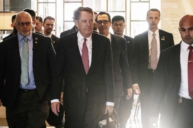 © Bloomberg. Robert Lighthizer, U.S. trade representative, center front, and Steven Mnuchin, U.S. Treasury secretary, center rear, arrive at a hotel in Beijing, China, on Thursday, March 28, 2019. Lighthizer and Mnuchin are in Beijing for high-level talks beginning Thursday, while top Chinese negotiator Vice Premier Liu He plans to travel to the U.S. the following week. Photographer: Gilles Sabrie/Bloomberg