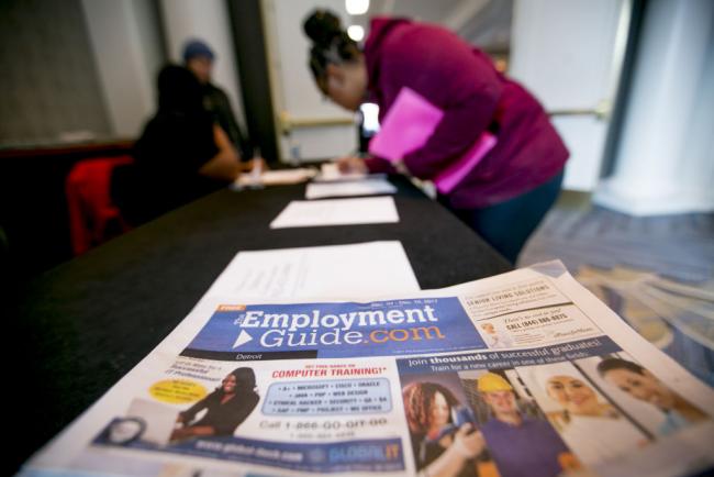 © Bloomberg. Employment Guide LLC literature sits on a table as a job seeker signs into a National Career Fairs event in Dearborn, Michigan, U.S., on Tuesday, Dec. 5, 2017. The U.S. Department of Labor is scheduled to release initial jobless claims figures on December 7.