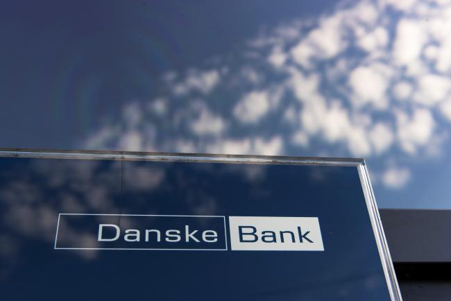 © Bloomberg. A logo sits on display in the window of a Danske Bank A/S bank branch in Copenhagen, Denmark, on Wednesday, Sept. 19, 2018. Danske Bank A/S Chief Executive Officer Thomas Borgen will step down amid allegations his bank was at the center of a major European money laundering scandal with as much as $234 billion flowing through a tiny unit in Estonia. Photographer: Freya Ingrid Morales/Bloomberg