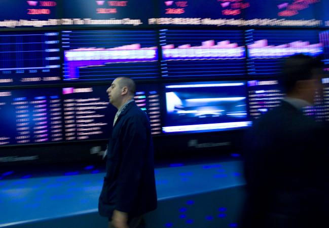 © Bloomberg. A trader walks past the board while working on the floor of the New York Stock Exchange in New York, U.S., on Tuesday, May 25, 2010.  Photographer: Jin Lee/Bloomberg