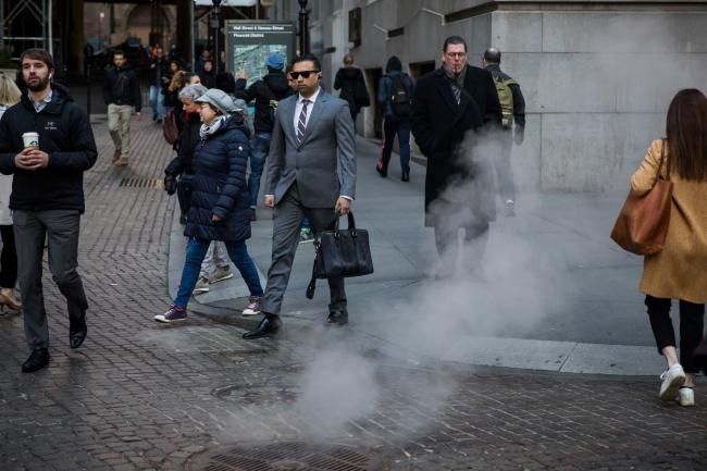 © Bloomberg. Pedestrians walk along Wall Street near the New York Stock Exchange (NYSE) in New York. Photographer: Michael Nagle/Bloomberg