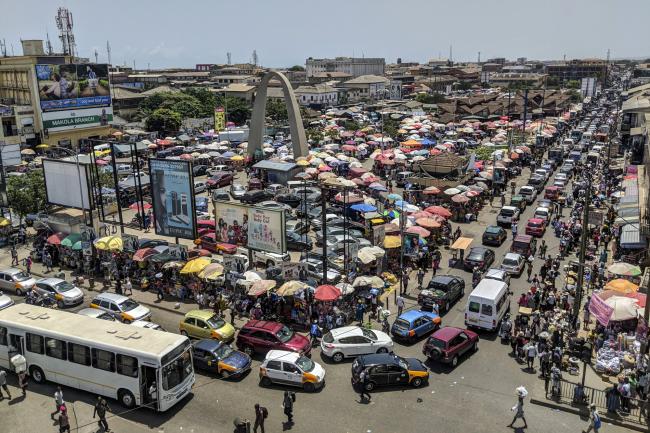© Bloomberg. Heavy automobile traffic passes by Makola market in Accra, Ghana, on Thursday, March 15, 2018. Ghana wants to shake up the way it collects tax with the International Monetary Fund telling the government that it’s not raising sufficient income. Photographer: Nicholas Seun Adatsi/Bloomberg